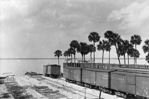 The photograph shows the South Florida Railroad depot at Sanford in 1883. Lake Monroe can be seen behind the depot. (State Archives of Florida)