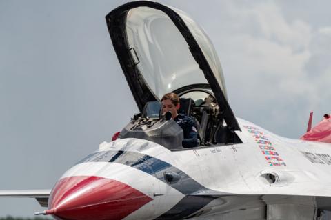 Major Michelle Curran, the lead solo pilot for the U.S. Air Force Thunderbirds gets ready to exit her F-16 after arriving in Sanford Monday afternoon.