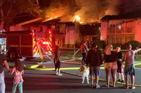 Neighbors watch as apartments at Goldelm at Charter Pointe burn down earlly Wednesday morning. Seminole County Fire Department officials said the apartments did not have working smoke detectors. 