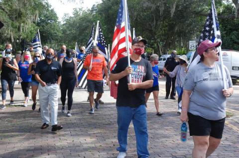 Participants walk down Park Avenue with flags and face masks during Saturday’s Back the Blue march, supporting law enforcement. 