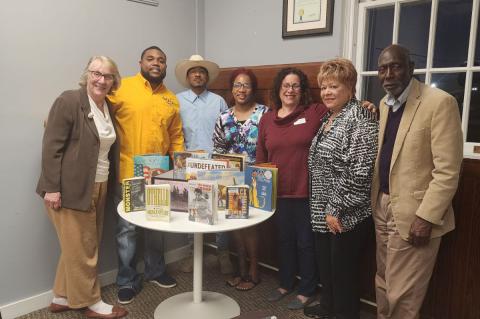Members of the Seminole County NAACP and Democratic Party in the Westside Community Center with books donated for the Freedom Library.