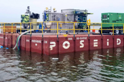 A harvesting unit mounted on a barge will be transported around Lake Jesup so that toxic blue-green algae can be harvested.