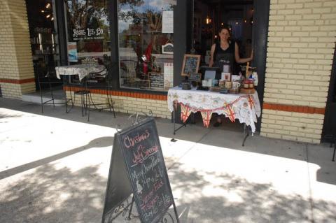 Rosie Lee Tea Co. Owner Kim Isaac outside of her store on Park Avenue during the Christmas in July event. 