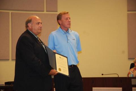 Former Mayor Jeff Triplett, right, who is president of the Greater Sanford Chamber of Commerce, accepts from current Mayor Art Woodruff, a proclamation commemorating the 100th anniversary of the Chamber.