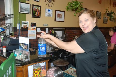 Colonial Room Restaurant Owner Michelle Simoneaux shows how careful employees are being by sanitizing between customers and meals. 