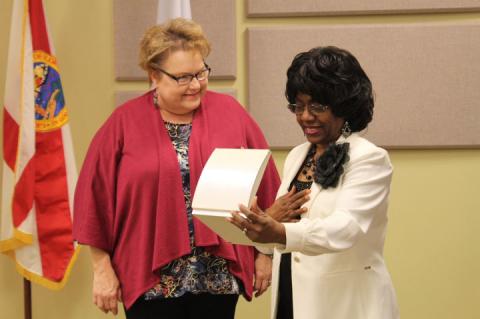 As a parting gift, the City Commissioners presented outgoing Commissioner Velma Williams (right)  with a specially-made necklace to remember them by.
