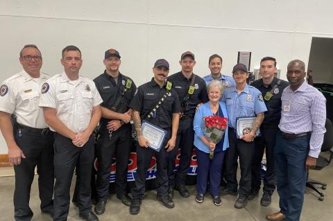Gayle Andrews, 84, (with flowers) pictured with Firefighter Jordan Rodriguez and the crew from Station 13.