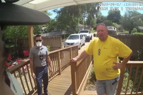 Camera footage shows Christopher Canfora (right) with a Volusia County deputy. 