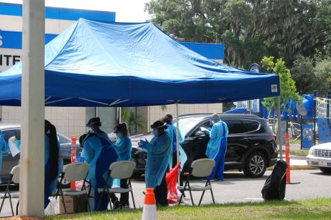 Cars line up at the Westside Community Center last week for one of the pop-up testing sites for the coronavirus.