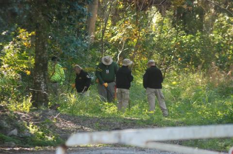 Members of the search party look for the body of Tiffany Church near E. 20th Street. 