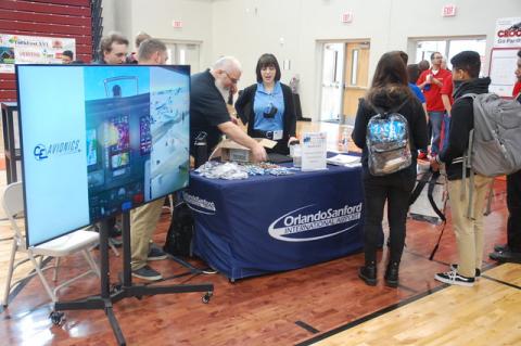Students talk with members of the Orlando Sanford International Airport at the 16th annual TechFest held at Crooms Academy of Information Technology in Sanford on Friday.