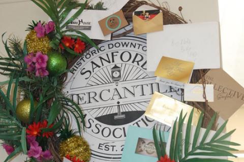 The Sanford Mercantile Association gave away this wreath at Christmas in July for one lucky shopper who had all 14 participating businesses fill in the checklist.