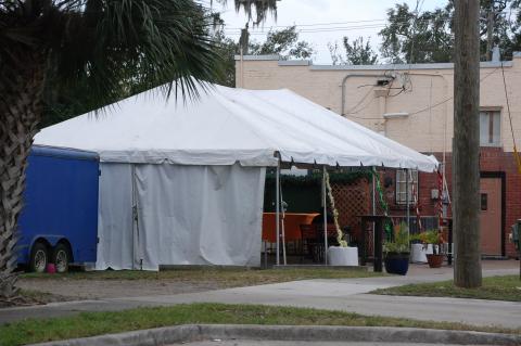The unauthorized tent at Shantell’s Just Until Restaurant (above) is still located behind the building despite warnings and violations from code enforcement.