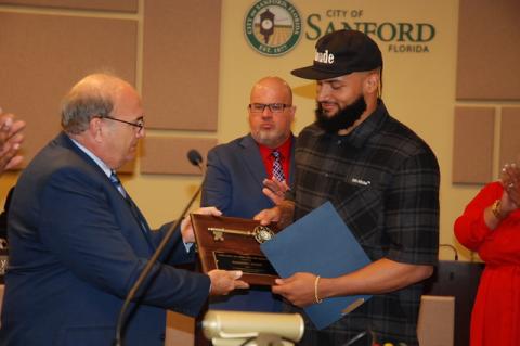 Mayor Art Woodruff (left) hands the key to the City of Sanford to NFL Player Gabriel Davis during Monday’s commission meeting.