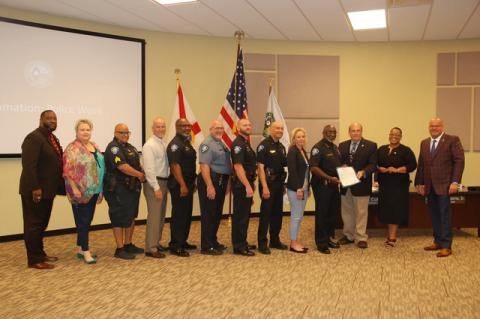 Sanford Police Chief Cecil Smith, fourth from the right, accepts a proclamation from Mayor Art Woodruff commemorating National Police Week, which ends May 15.