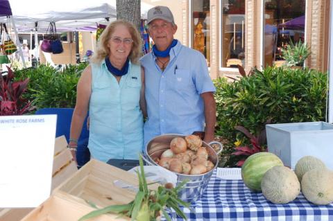 Paula and George Martin of Oviedo’s White Rose Farms, selling at the Farmer’s Market in Magnolia Square in Sanford on Saturday.