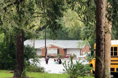 Residents on Lily Court (above) work to get out of their homes during a flash flood that took place on Thursday, Sept. 29 following Hurricane Ian.