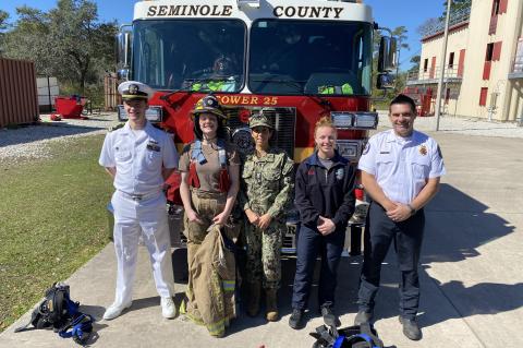 Members of the U.S. Navy and the Seminole County Fire Department stand together during Daytona Beach Navy Week.