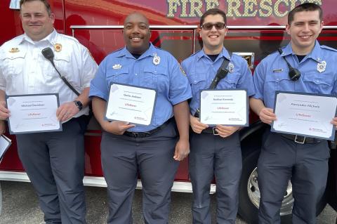 Lieutenant/Paramedic Michael Davidson, Firefighter/EMT Nathan Kennedy, Firefighter/EMT Alexander Nichols, Firefighter/Paramedic Gavin Jackson with their awards on Friday. 