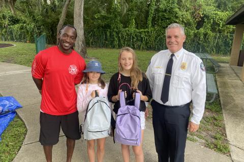 Seminole Fire Chief Matt Kinley (top, right) with children and members of the Seminole County Fire Department (below) for the Back to School Bash