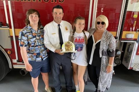 Longwood resident Jason Moore (center) with his family during his recent promotion to Battalion Chief at the Seminole County Fire Department (SCFD).