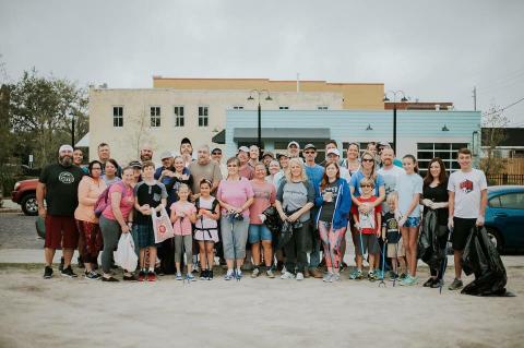 A group of people pose following one of the first Sanford Clean Up projects in town. 