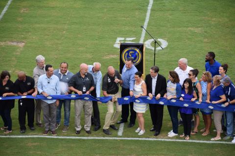  Lyman Principal Mike Rice (center) along with school officials cut the ribbon for the new field. 