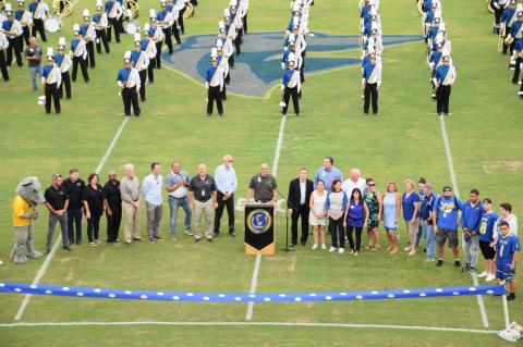 Lyman Principal Mike Rice speaks to the crowd during the ribbon cutting ceremony for the football field.
