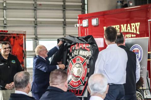 Lake Mary Mayor David Mealor (left) unveils the Lake Mary Fire Department’s new logo during a ceremony last Friday. 