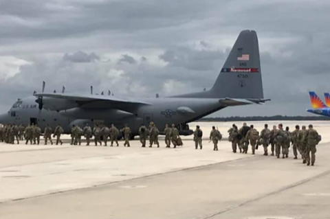 Members of the National Guard board a C-130 military transport plane to head to Washington D.C this week to help with violent protests. 