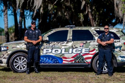Officers Bobby Draughon (left) and Ryan Dauzat helped design the newly wrapped vehicle.