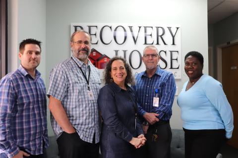 Employees Daniel Hudson (left), Paul Kestler, Julia Mantooth, Ed Carr, and Rosalyn Thomas stand at the Recovery House facility office.