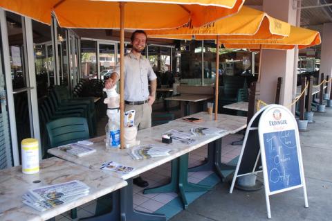 Hollerbach’s Willow Tree Cafe Manager Matt Crowe stands out front of the restaurant Wednesday to fill curbside orders.