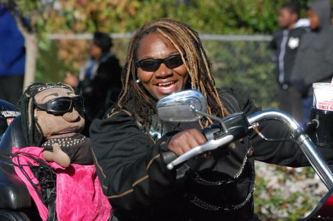 Shantell Williams with her “mini me” stuffed puppet on her motorcycle during the last Martin Luther King Jr. parade. 
