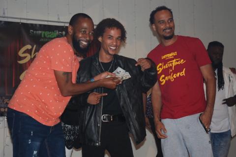 Cameron Osterloh (center), 26, of Ocala took home the $500 cash prize at October’s Showtime in Sanford held Wednesday at the Woman’s Club of Sanford. Cameron Osterloh poses with Showtime in Sanford host Jay love, left, and Laurence Gordon of Surrealist Entertainment, which produces the shows.