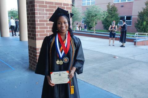 Alice Abia-Okon proudly shows off her diploma. She plans to attend the University of Florida.