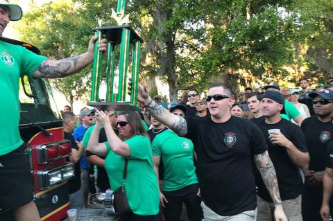 Last year’s winner takes the trophy for the truck pull at the St. Paddy’s Day Truck Pull and Street Festival.