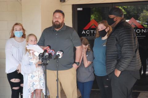 Cory Campbell talks about his wife, Jenica, who died Monday in a vehicular homicide. His four daughters surround him along with Action Church Pastor Kenneth Clark.