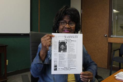 Commissioner Velma Williams, holding up a copy of the ad she ran in the Sanford Herald in 1996 when she first started her run.