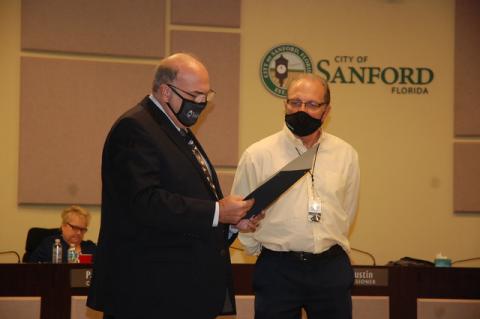 Sanford Mayor Art Woodruff reads a proclamation declaring April 2021 as Water Conservation Month Monday evening as Bill Marcous, the city’s utilities support manager looks on.