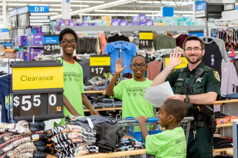 Kids shop at Walmart (above) with a deputy from the Seminole County Sheriff’s Office for back-to-school supplies during the 15th Annual Shop with the Sheriff event. 
